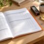 A tax depreciation schedule report open on a timber desk beside a laser measure and tape measure